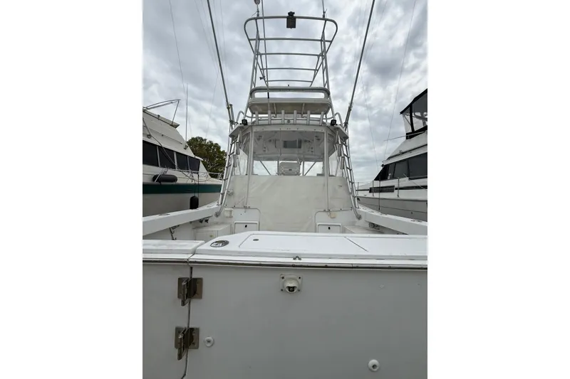 Slide: The Image of 1999 Luhrs Tournament 320 Open boat with tower, docked among other vessels. - 7