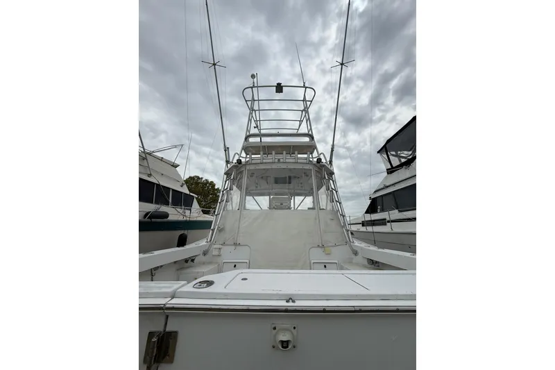 Slide: The Image of 1999 Luhrs Tournament 320 Open boat with tower, docked under cloudy skies. - 8