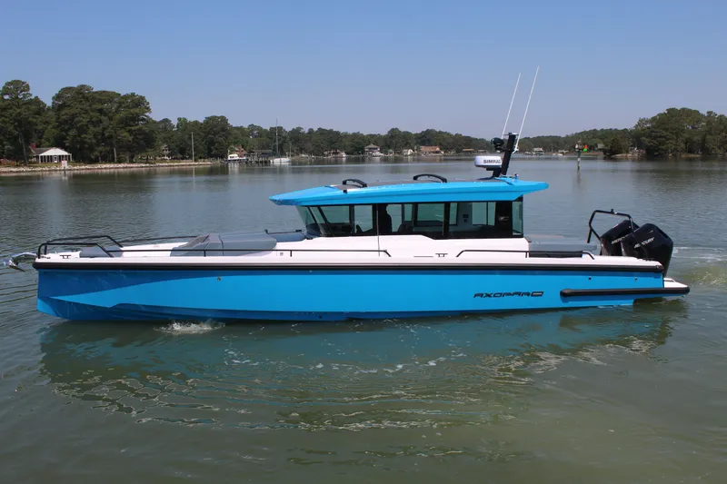Slide: The Image of 2026 Axopar 37 XC Cross Cabin on calm waters. - 2
