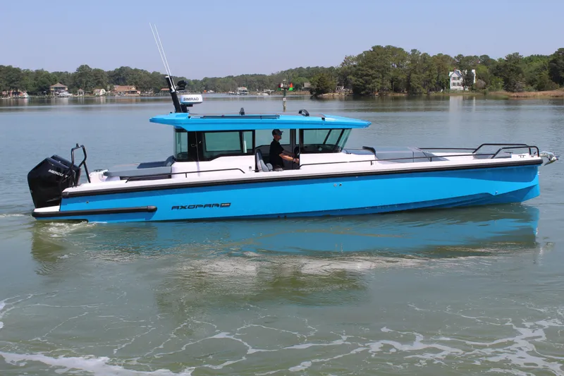 Slide: The Image of 2026 Axopar 37 XC Cross Cabin on calm water. - 6