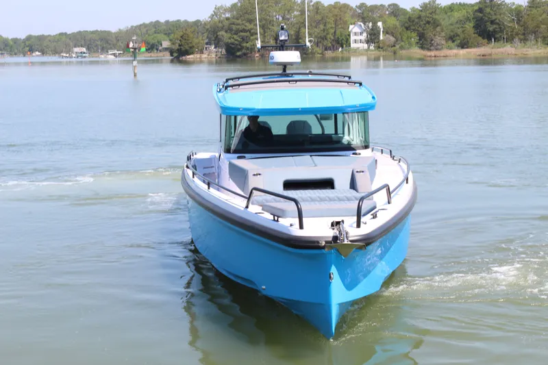 Slide: The Image of 2026 Axopar 37 XC Cross Cabin on calm waters. - 7
