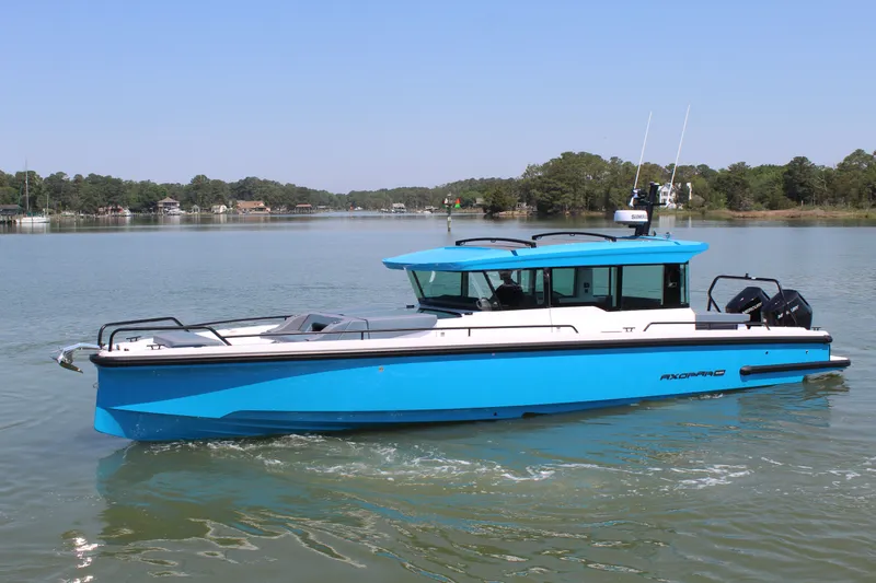 Slide: The Image of 2026 Axopar 37 XC Cross Cabin on calm waters. - 8