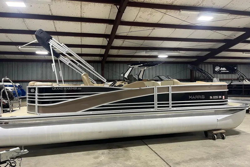 The Image of 2015 Harris Grand Mariner 250 pontoon boat in indoor storage facility. - 1