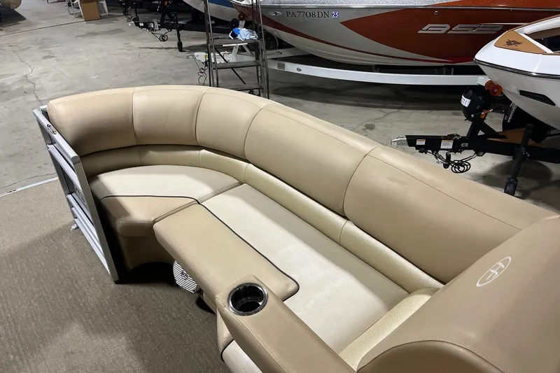 Slide: The Image of Luxurious seating on a 2015 Harris Grand Mariner 250 pontoon boat, featuring beige upholstery. - 10