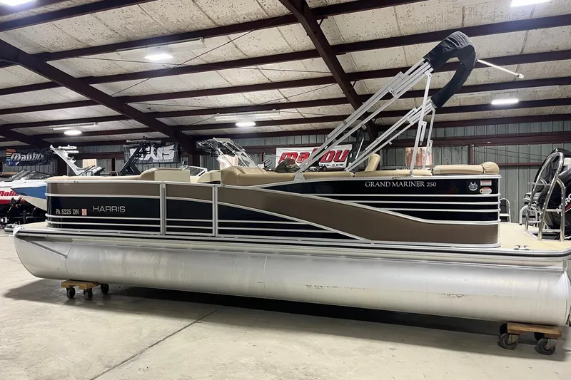 Slide: The Image of 2015 Harris Grand Mariner 250 pontoon boat in indoor showroom setting. - 5