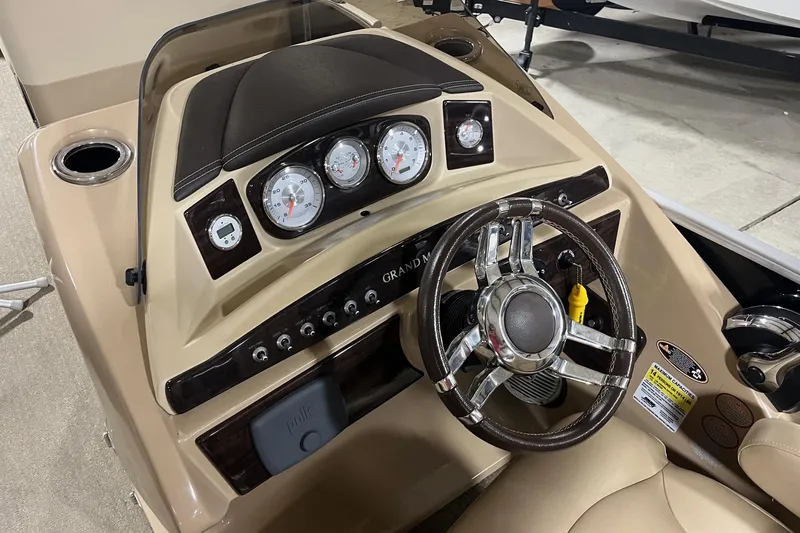 Slide: The Image of 2015 Harris Grand Mariner 250 dashboard with gauges and steering wheel. - 8