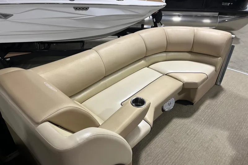 Slide: The Image of Luxurious seating on a 2015 Harris Grand Mariner 250 pontoon boat, featuring beige upholstery. - 9