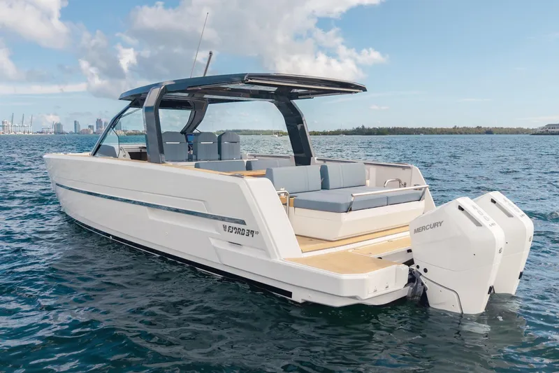 Slide: The Image of 2026 Fjord 39 XP boat on water with dual Mercury engines, sleek design. - 2