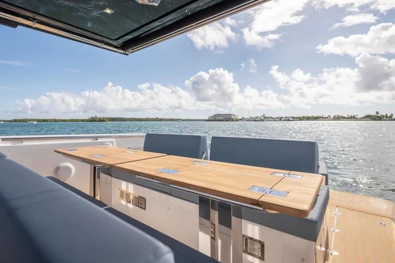 Slide: The Image of Luxury deck view on 2026 Fjord 39 XP yacht, featuring sleek seating and ocean backdrop. - 7