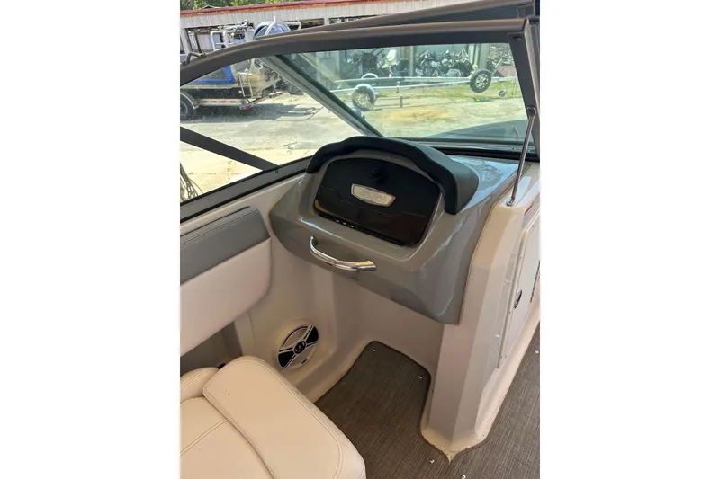 Slide: The Image of 2020 Chaparral 19 SSi boat interior dashboard with seating and speaker. - 4