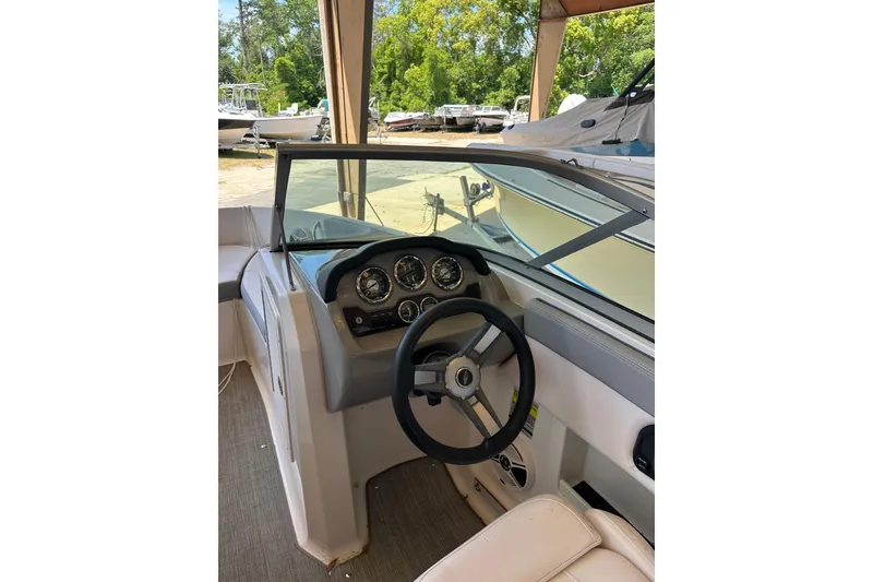 Slide: The Image of 2020 Chaparral 19 SSi boat dashboard with steering wheel and gauges. - 7