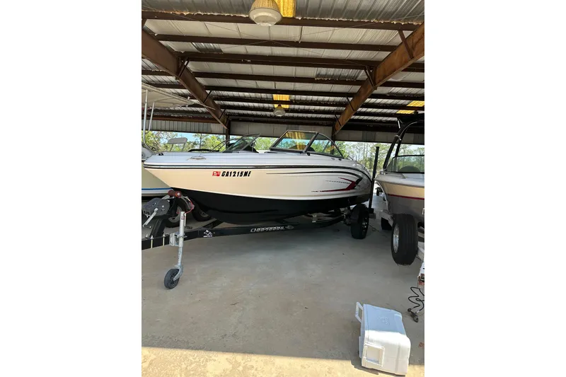 Slide: The Image of 2020 Chaparral 19 SSi boat in covered storage, on a trailer. - 9