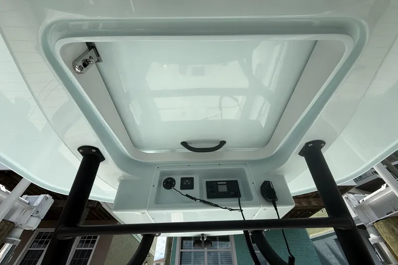 Slide: The Image of Underside view of 2023 Yellowfin 26 Hybrid boat console with electronic controls. - 11