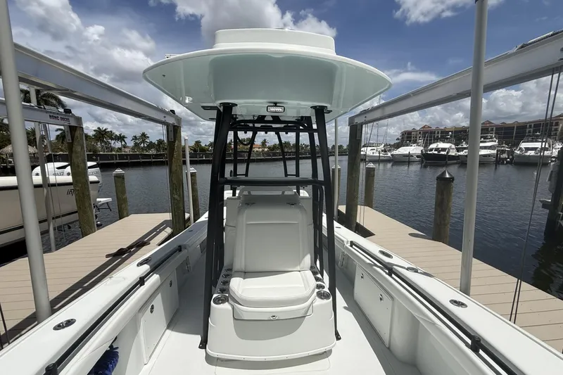 Slide: The Image of 2023 Yellowfin 26 Hybrid boat docked at marina under cloudy sky. - 13