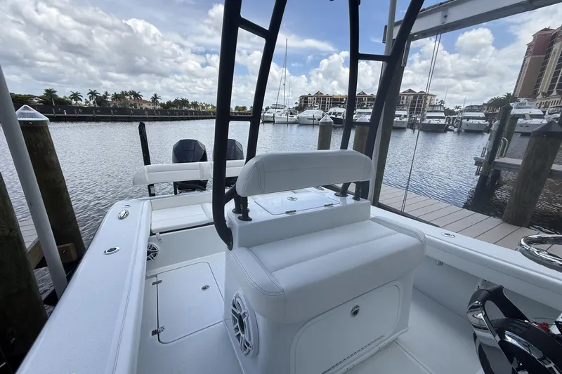 Slide: The Image of 2023 Yellowfin 26 Hybrid boat docked at marina with scenic waterfront view. - 17