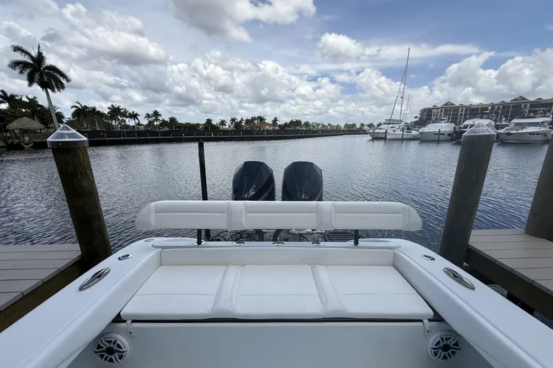 Slide: The Image of 2023 Yellowfin 26 Hybrid boat docked at marina with scenic waterfront view. - 19