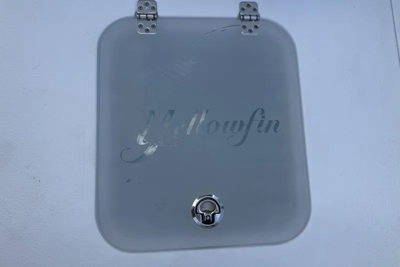 Slide: The Image of 2023 Yellowfin 26 Hybrid boat hatch with logo and metal latch. - 20
