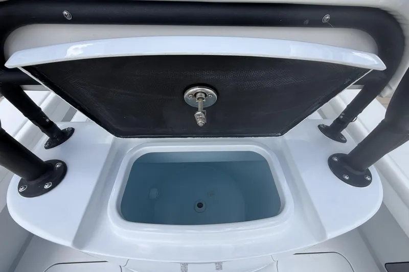 Slide: The Image of 2023 Yellowfin 26 Hybrid boat livewell with open lid and sturdy black supports. - 22