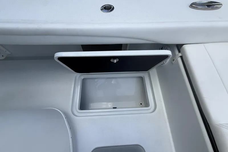 Slide: The Image of Open storage compartment on 2023 Yellowfin 26 Hybrid boat deck. - 23