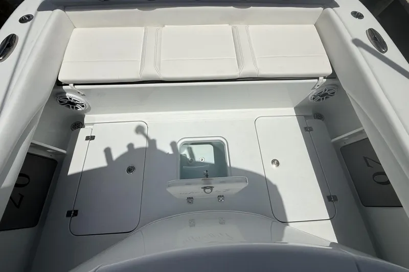 Slide: The Image of 2023 Yellowfin 26 Hybrid boat interior with white seating and storage compartments. - 25