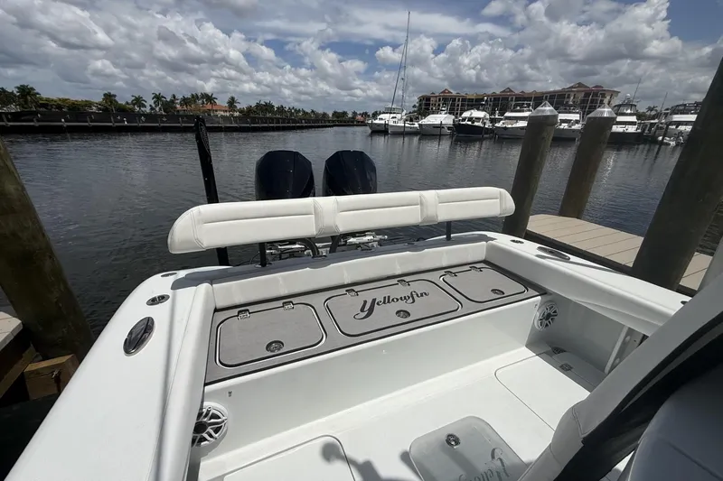 Slide: The Image of 2023 Yellowfin 26 Hybrid boat docked at marina, featuring sleek design and spacious deck. - 26