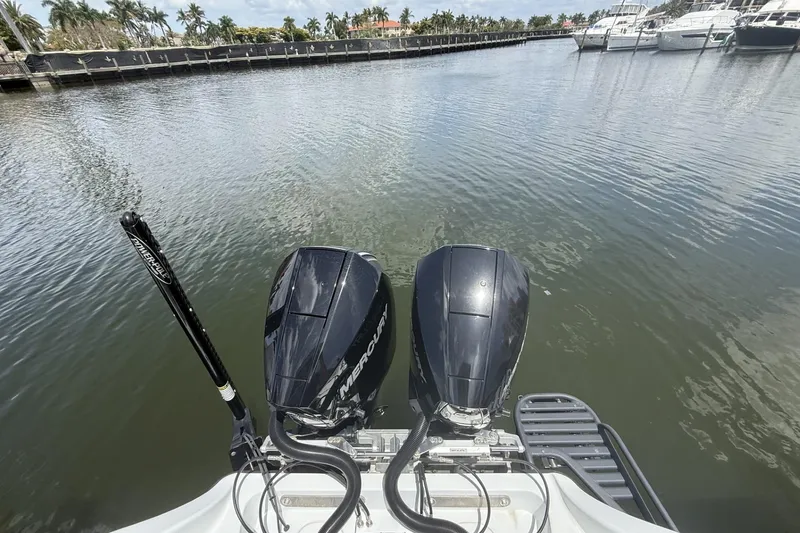 Slide: The Image of 2023 Yellowfin 26 Hybrid boat with dual Mercury outboard engines at a marina. - 29