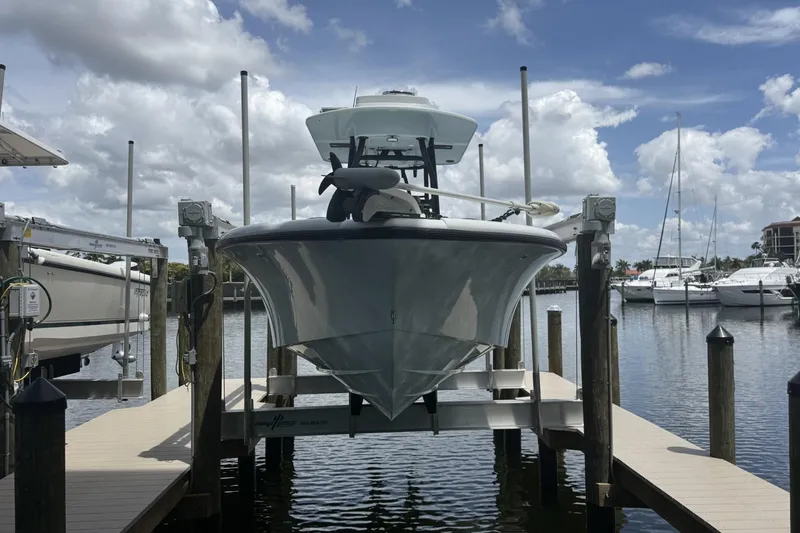Slide: The Image of 2023 Yellowfin 26 Hybrid boat docked at marina under cloudy sky. - 3