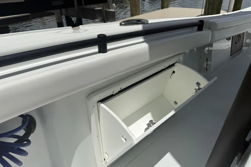 Slide: The Image of 2023 Yellowfin 26 Hybrid boat storage compartment open, dockside view. - 31