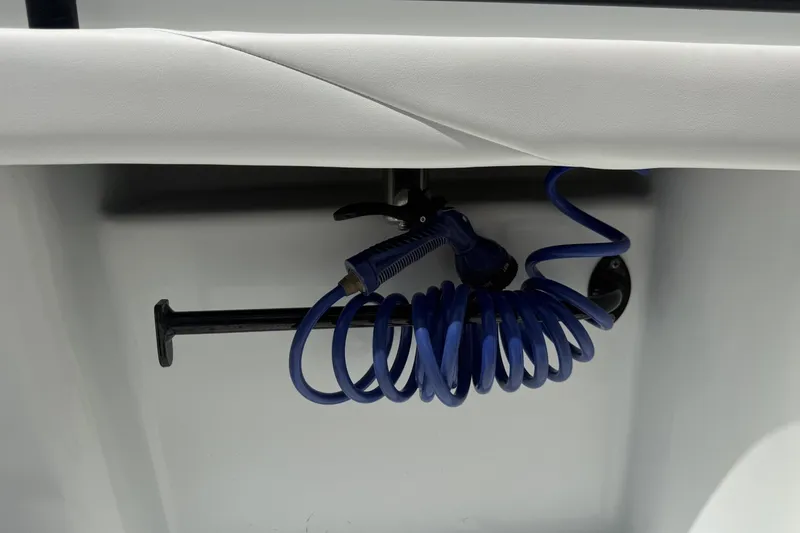 Slide: The Image of Coiled blue hose and nozzle on 2023 Yellowfin 26 Hybrid boat. - 32