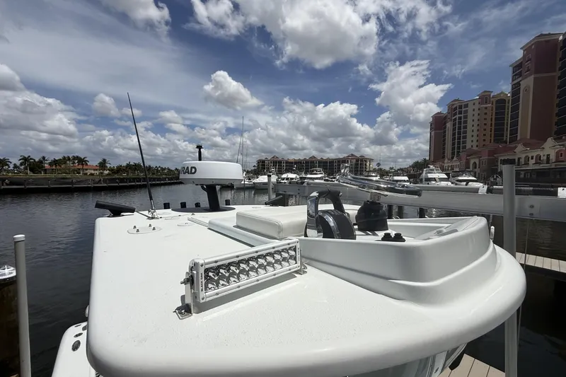 Slide: The Image of 2023 Yellowfin 26 Hybrid boat docked at marina under cloudy sky. - 33