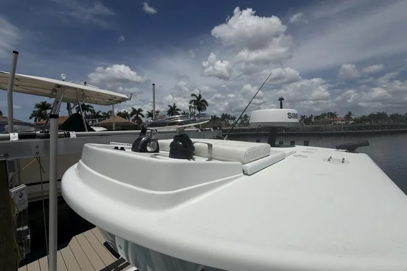 Slide: The Image of 2023 Yellowfin 26 Hybrid boat docked under a partly cloudy sky. - 34