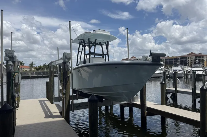 Slide: The Image of 2023 Yellowfin 26 Hybrid boat docked at marina under cloudy sky. - 4