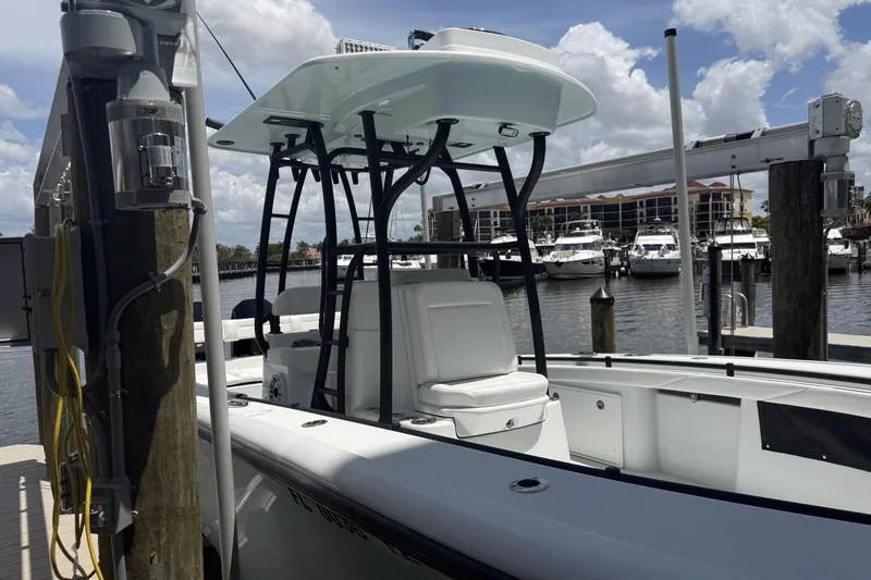 Slide: The Image of 2023 Yellowfin 26 Hybrid boat docked at marina with clear sky background. - 40