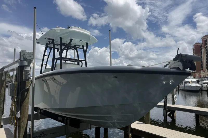 Slide: The Image of 2023 Yellowfin 26 Hybrid boat docked under a cloudy sky. - 7