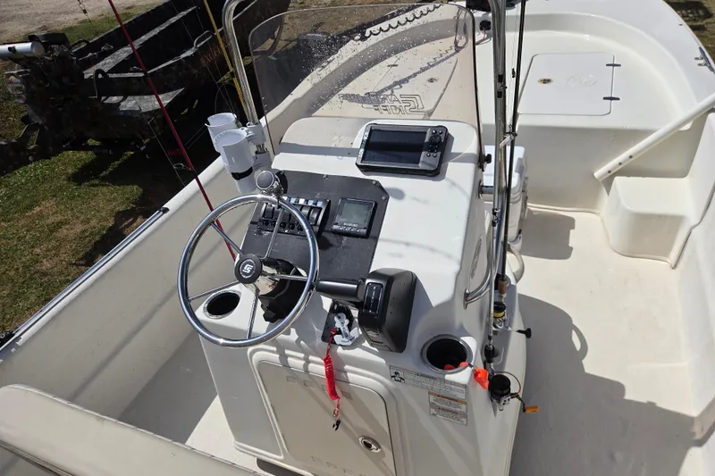 Slide: The Image of 2017 Carolina Skiff 198 DLX boat console with steering wheel and navigation equipment. - 13