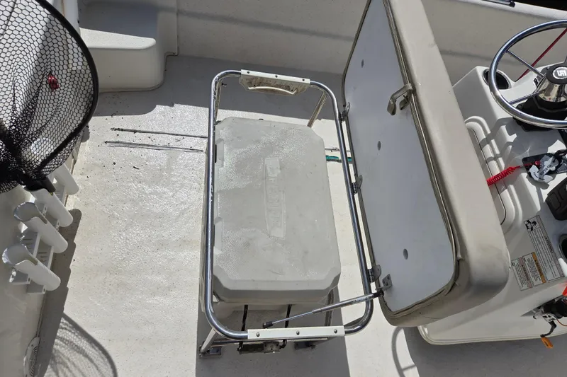 Slide: The Image of 2017 Carolina Skiff 198 DLX boat interior with steering console and storage compartment. - 14
