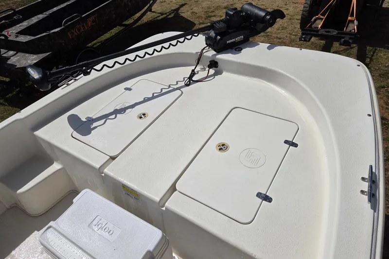 Slide: The Image of 2017 Carolina Skiff 198 DLX boat deck with storage compartments and trolling motor. - 16
