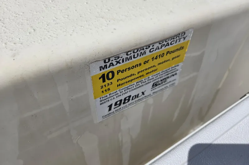 Slide: The Image of 2017 Carolina Skiff 198 DLX capacity label, 10 persons or 1410 pounds. - 17