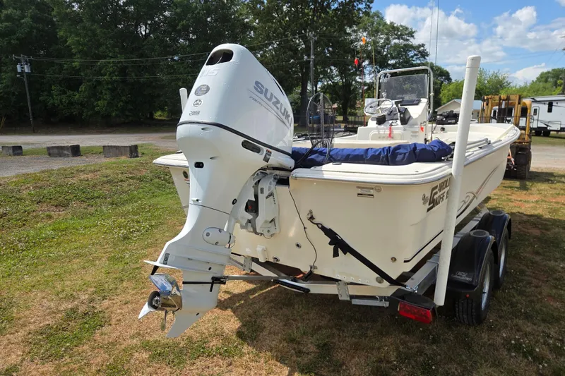 Slide: The Image of 2017 Carolina Skiff 198 DLX boat with Suzuki outboard motor on trailer. - 5