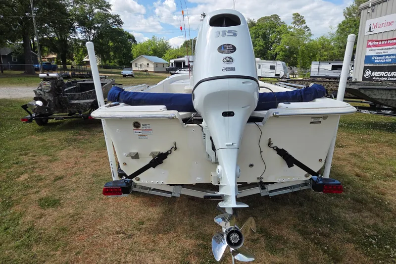 Slide: The Image of 2017 Carolina Skiff 198 DLX boat with outboard motor, parked on grass. - 6