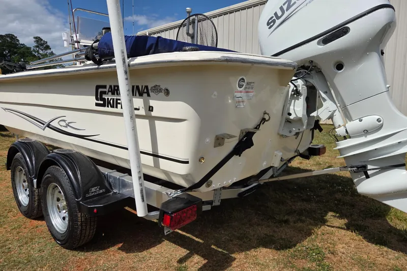 Slide: The Image of 2017 Carolina Skiff 198 DLX boat with Suzuki outboard motor on trailer. - 8