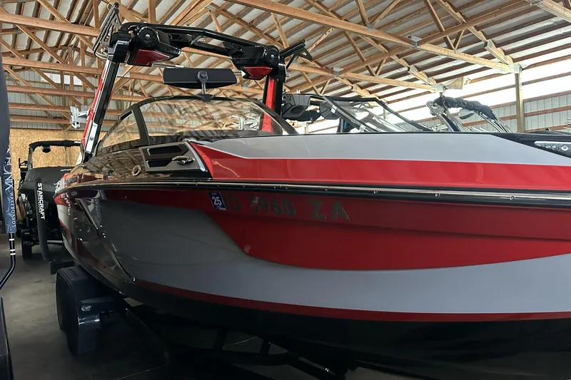 Slide: The Image of 2021 Centurion Ri245 boat in a wooden storage facility. - 19