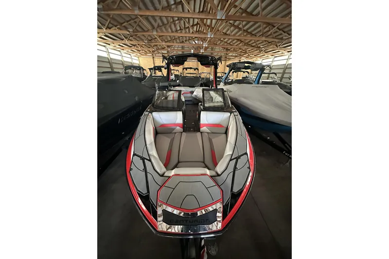 Slide: The Image of 2021 Centurion Ri245 boat with sleek design and red accents in a storage facility. - 20
