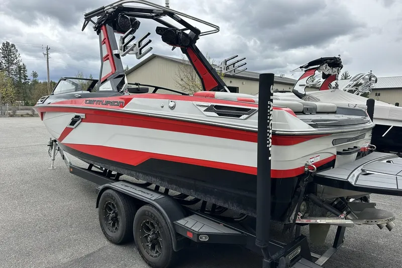 Slide: The Image of 2021 Centurion Ri245 boat with red and white design on a trailer. - 4