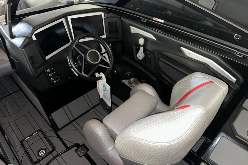 Slide: The Image of 2021 Centurion Ri245 boat interior with modern dashboard and sleek steering wheel design. - 8