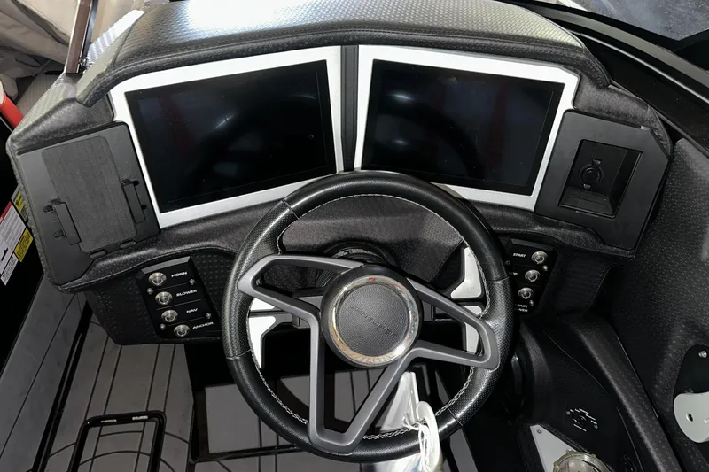 Slide: The Image of Dashboard of a 2021 Centurion Ri245 boat with dual screens and steering wheel. - 9