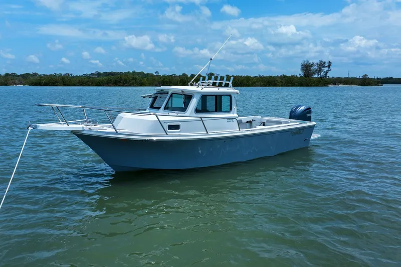 Slide: The Image of Parker 2320 Sport Cabin 2024 on calm waters. - 0