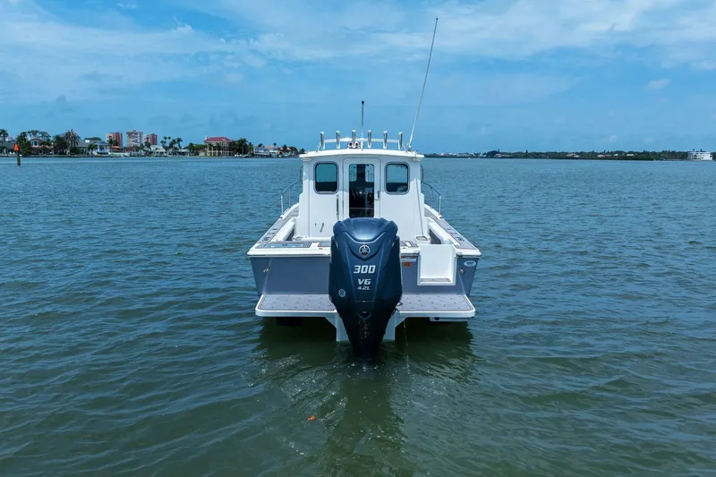 Slide: The Image of 2024 Parker 2320 Sport Cabin boat on calm water. - 1