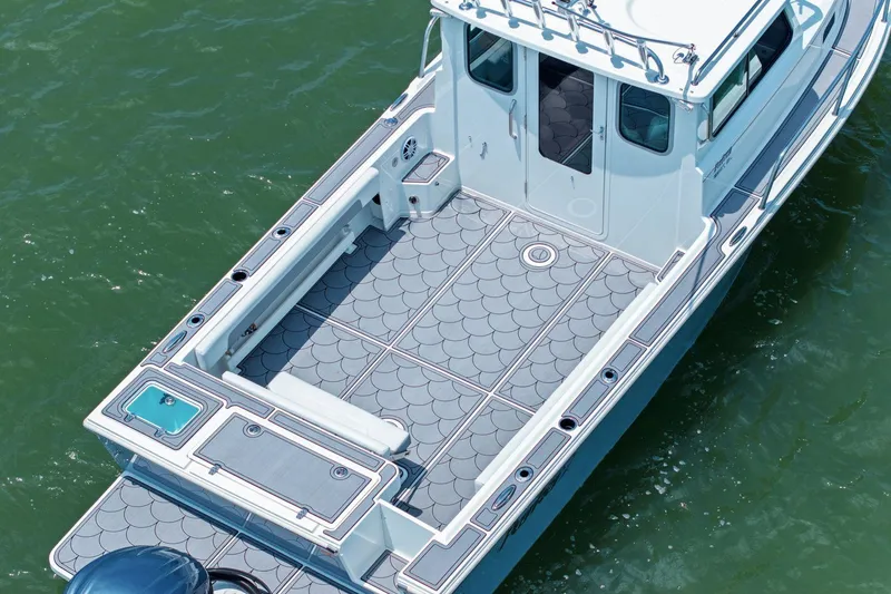 Slide: The Image of Parker 2320 Sport Cabin 2024 on water, spacious deck design. - 11