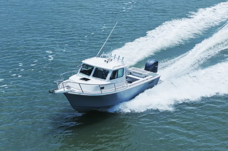 Slide: The Image of Parker 2320 Sport Cabin 2024 cruising swiftly on the water. - 12